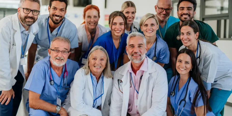 Portrait of happy doctors, nurses and other medical staff in a hospital.